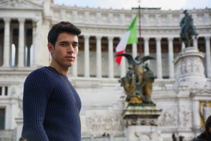 Handsome young man in Rome in front of Vittoriano monument