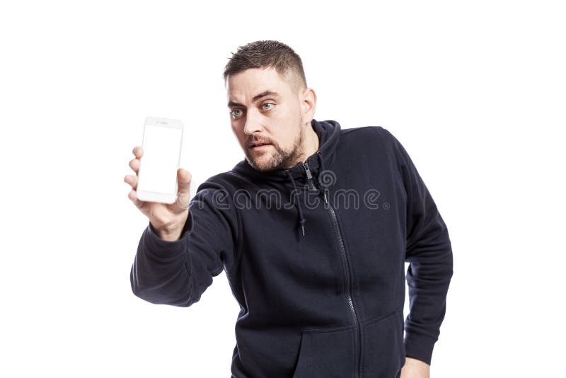 Handsome young man shows a phone with an isolated screen. Isolated over white background royalty free stock image Handsome young man shows a phone with an isolated screen. Isolated over white background royalty free stock image