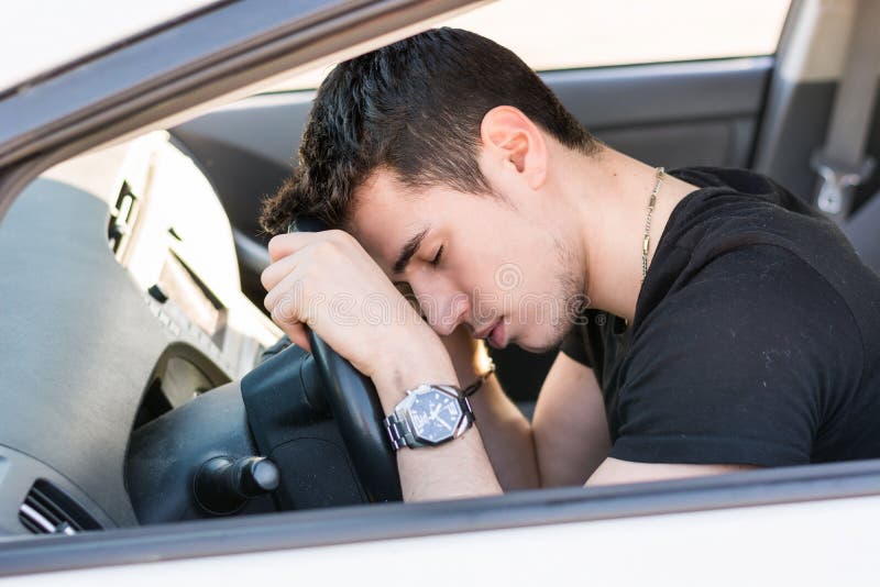 Handsome Young Man sleeping in a Car stock images Handsome Young Man sleeping in a Car stock images