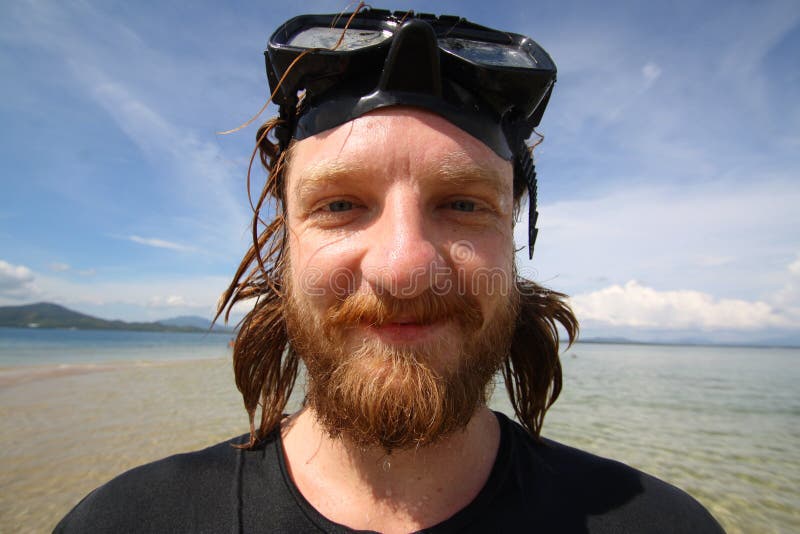 Handsome young man with smiley face during the snorkeling in the sea