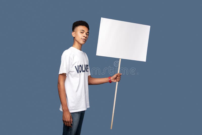 Handsome young man standing against blue background