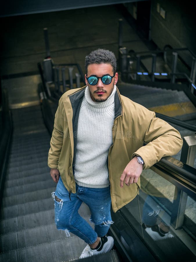 Handsome young man standing outdoors in city stock photo Handsome young man standing outdoors in city stock photo