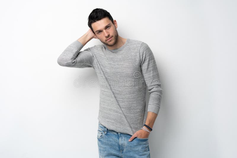 Handsome young man on white background looking at camera. Happy guy smiling