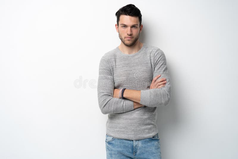 Handsome young man on white background looking at camera. Happy guy smiling