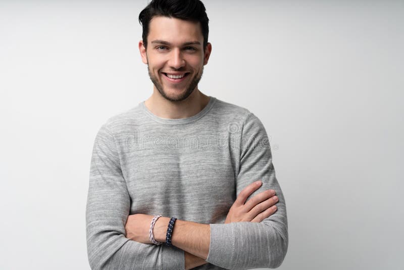 Handsome young man on white background looking at camera. Happy guy smiling