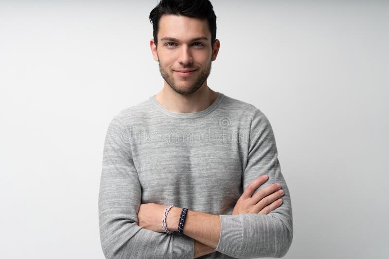 Handsome young man on white background looking at camera. Happy guy smiling