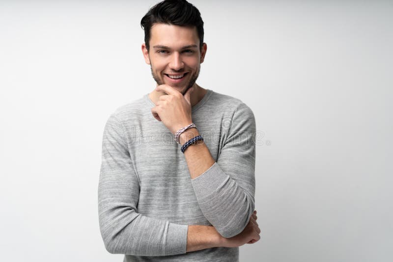 Handsome young man on white background looking at camera. Happy guy smiling