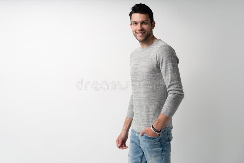 Handsome young man on white background looking at camera. Happy guy smiling