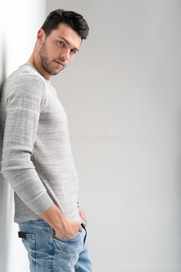 Handsome young man on white background looking at camera. Happy guy smiling