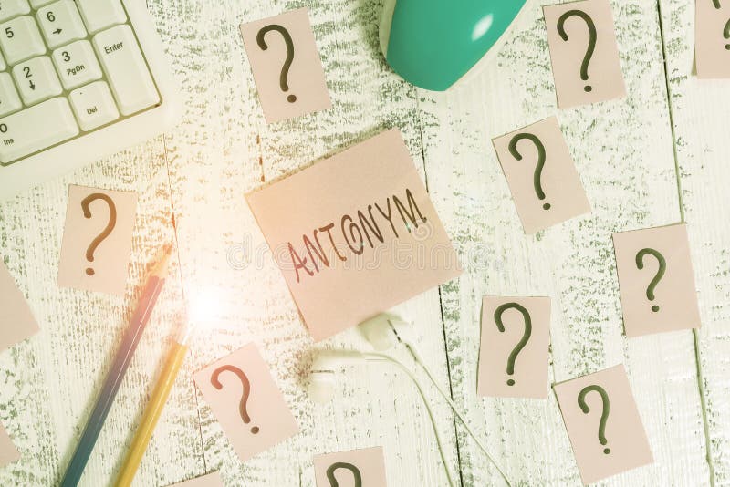 Handwriting text writing Antonym. Concept meaning word or phrase whose meaning is the opposite of another word Writing tools royalty free stock photos