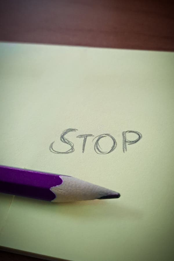Handwritten pencil text with bold word STOP on white background royalty free stock photo