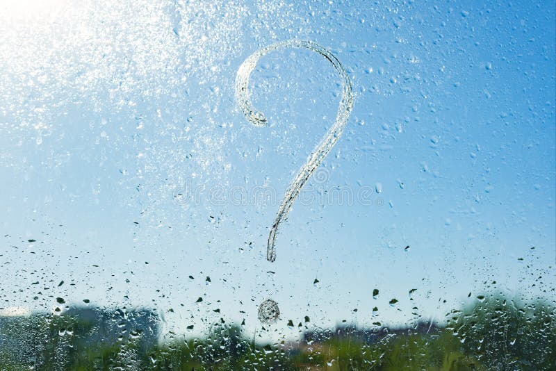 Handwritten question mark on rainy window. Background drop of water on the glass, blue sky, sun stock photography