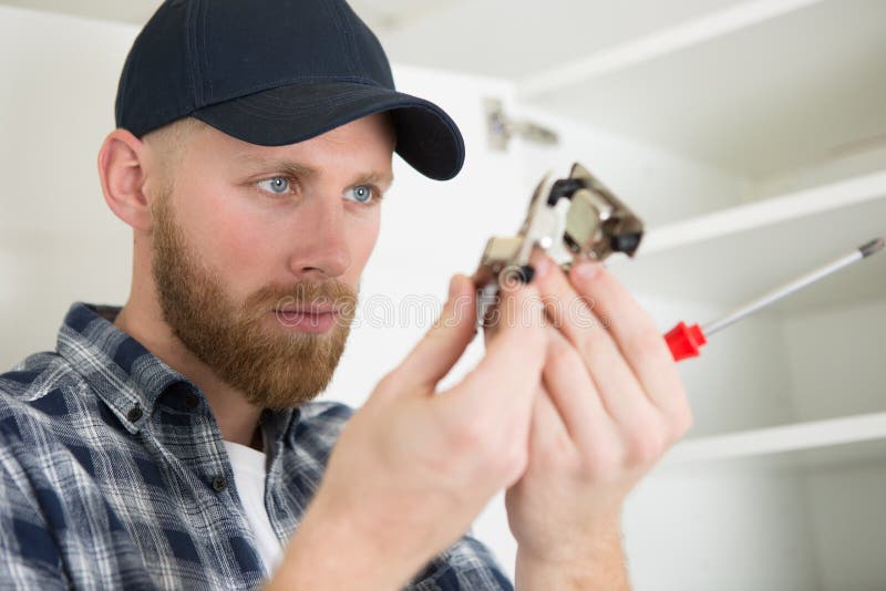 Handyman fitting new door stock image. Image of joiner 267207771