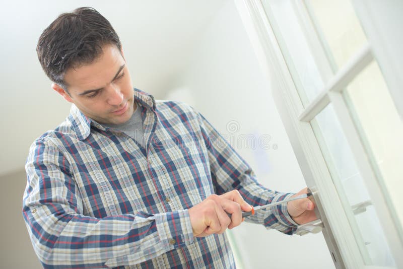 Handyman fitting new door stock image. Image of handyman 89691543
