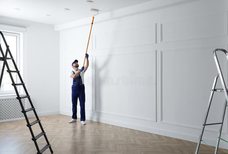 Handyman Painting Ceiling with White Dye Indoors, Space for Text Stock