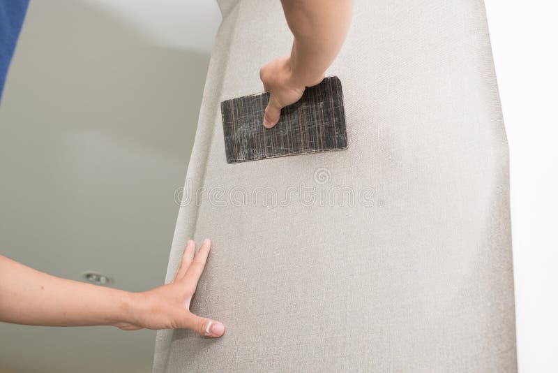 Handyman Putting Up Wallpaper on the White Walls Stock Image Image of