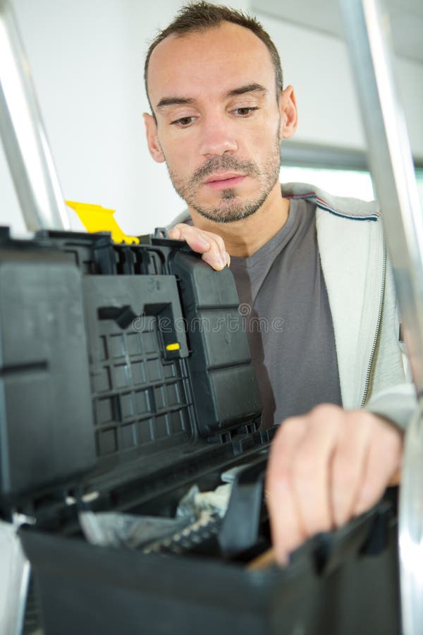 Handyman Selecting Tool from Toolbox Stock Image Image of site