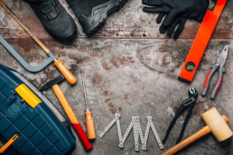 Handyman tool kit with assorted tools, safety boots, goggles royalty free stock photo