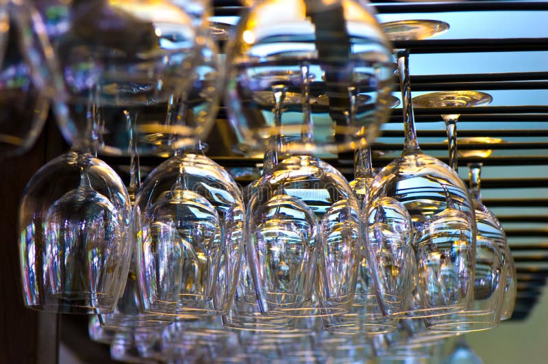 Hanging wineglasses, selective focus, lot of color reflections and chromatic aberrations left intentionally. Hanging wineglasses, selective focus, lot of color reflections and chromatic aberrations left intentionally