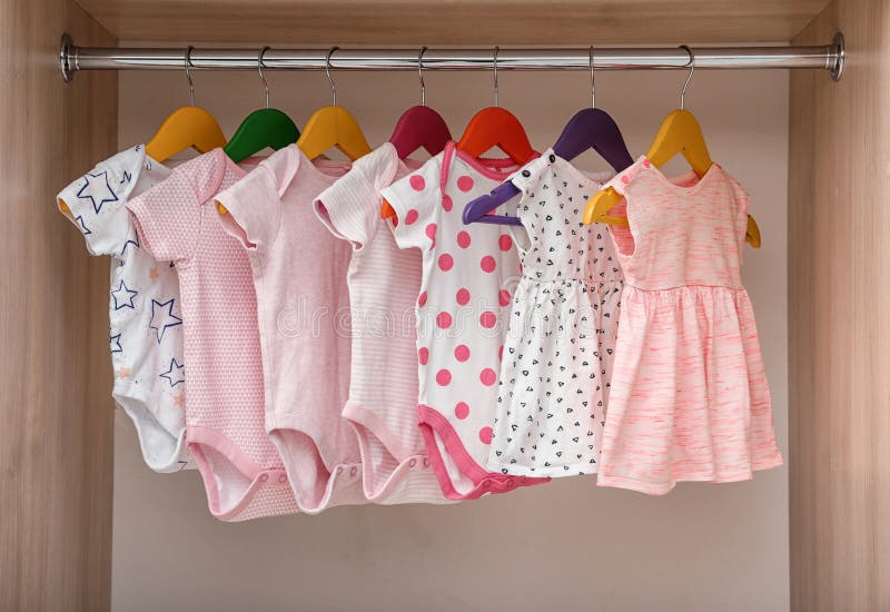 Hangers with Baby Clothes on Rack in Wardrobe Stock Image Image of