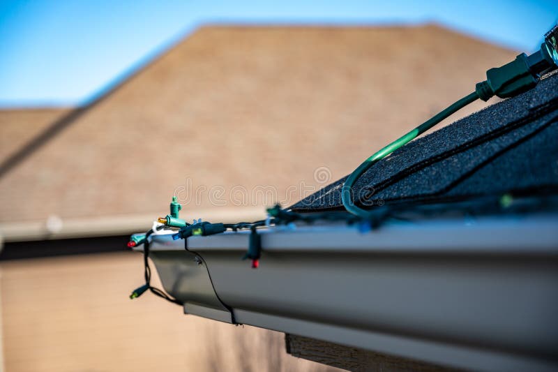 Hanging Christmas Lights on Gutter with Plastic Clips Stock Image