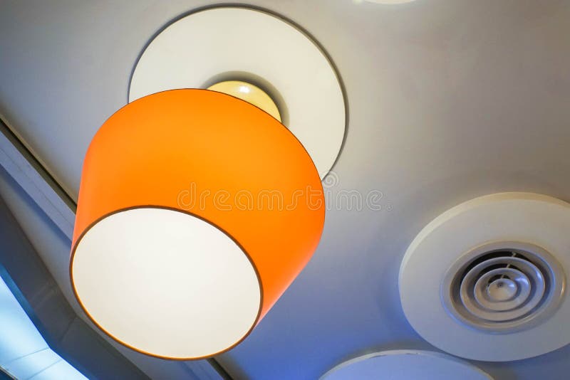 Hanging orange glow lamp on restaurant ceiling royalty free stock images