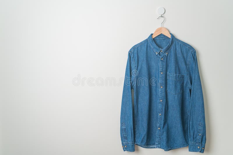 Hanging Shirt with Wood Hanger on Wall Stock Photo - Image of denim ...