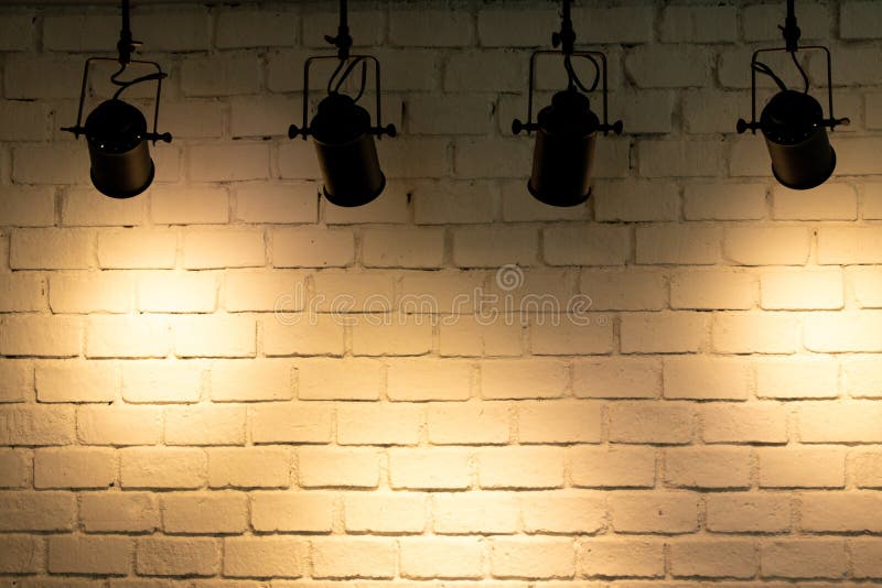 Hanging Spotlight Illuminate at Brick Wall Background Stock Image