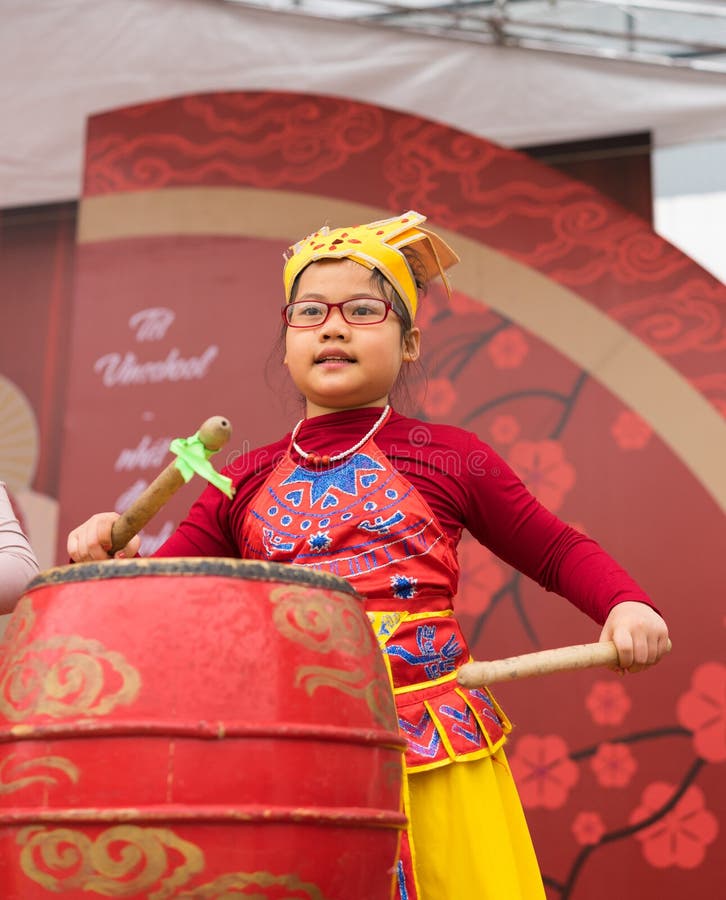 Hanoi, Vietnam - Feb 7, 2015: School pupil perform a drum show on stage at Vietnamese lunar new year festival organized at Vinscho royalty free stock photo Hanoi, Vietnam - Feb 7, 2015: School pupil perform a drum show on stage at Vietnamese lunar new year festival organized at Vinscho royalty free stock photo