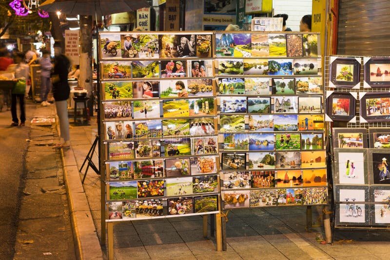 Hanoi, Vietnam - Nov 2, 2014: Photo prints and map on racks of a small mobile shop for selling to tourist on Ma May street, old qu