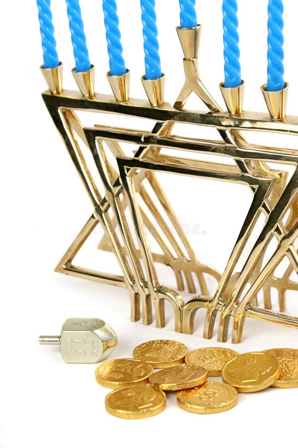 A menorah with candles along with a dreidel and chocolate Hanukah gelt. Isolated. (trademarks removed, only hebrew symbols left). A menorah with candles along with a dreidel and chocolate Hanukah gelt. Isolated. (trademarks removed, only hebrew symbols left)