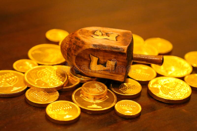 Hanukkah dreidel gold gelt coins on a table stock photos Hanukkah dreidel gold gelt coins on a table stock photos