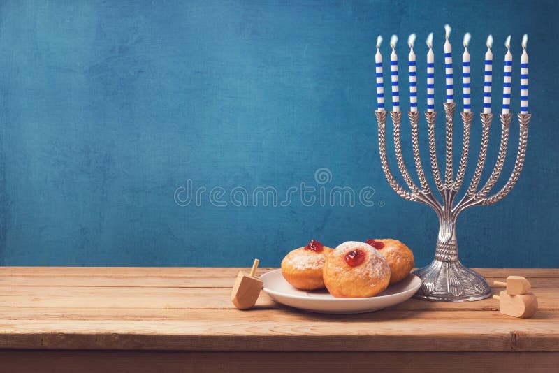 Hanukkah holiday sufganiyot and menorah on wooden table