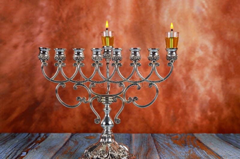 Jewish holiday Hanukkah with lighting the first candle on a hanukkah menorah traditional candelabra. Hanukkah with menorah jewish holiday traditional candelabra royalty free stock photo Jewish holiday Hanukkah with lighting the first candle on a hanukkah menorah traditional candelabra. Hanukkah with menorah jewish holiday traditional candelabra royalty free stock photo
