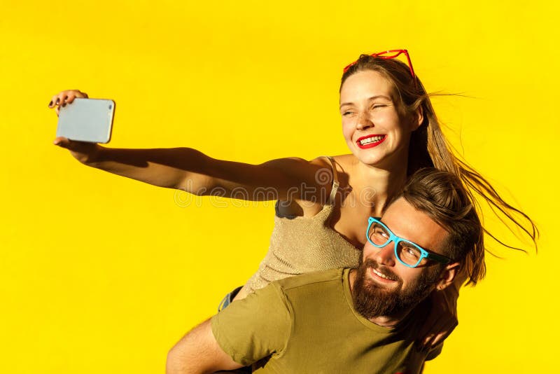 Happiness couple. Piggyback. Selfie stock photos