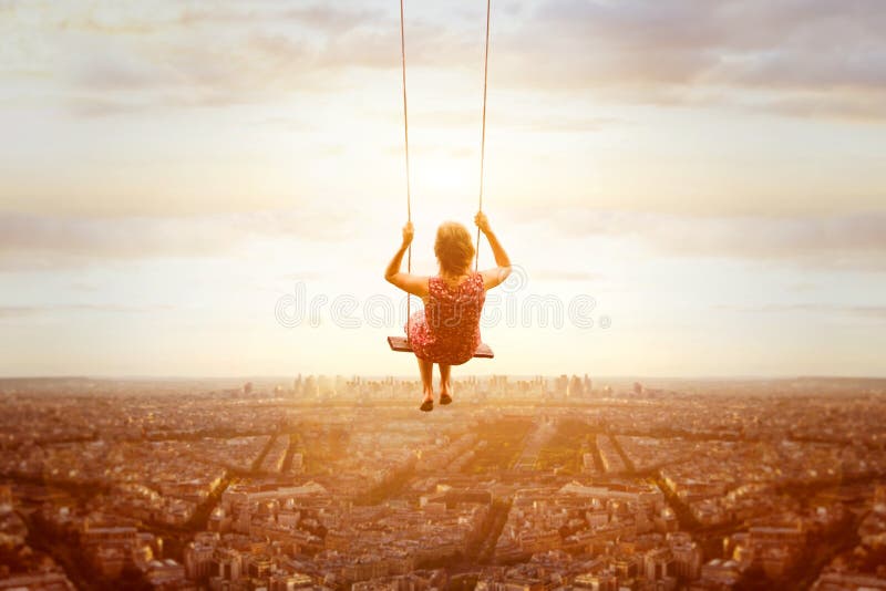 Happiness and freedom concept, happy girl on swing. Happiness and freedom concept, happy romantic beautiful young girl on the swing above the city landscape