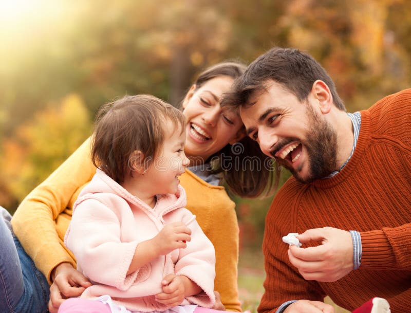 Nice young family of three enjoy in picnic royalty free stock images Nice young family of three enjoy in picnic royalty free stock images