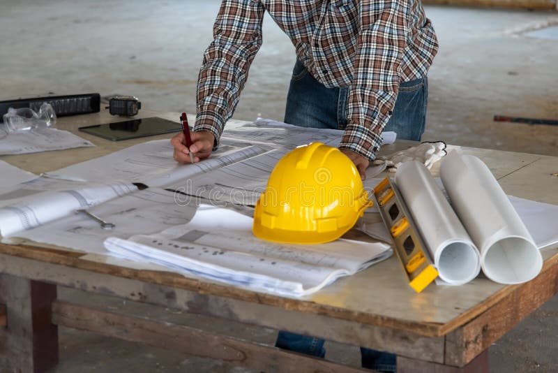 Happiness smile professional businessman consulting with engineering/ architecture in construction renovate building site. stock images