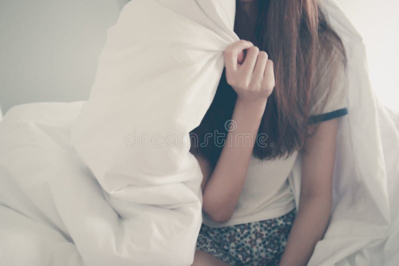 Happiness of young Asian woman lying with blanket on bed in the morning. Winter day. Copy space.