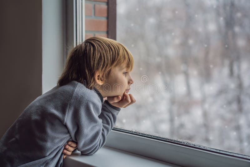 kid looking outside the window