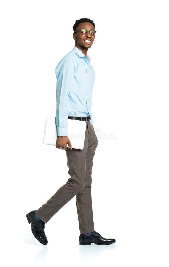 Happy african american college student standing with laptop on w