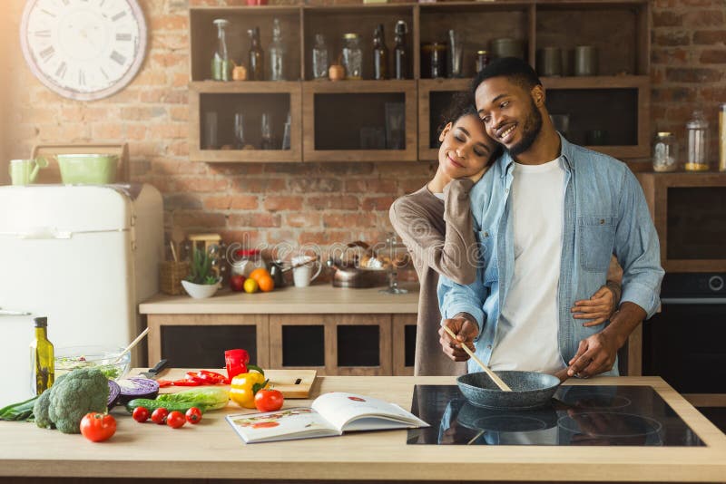 Happy black couple cooking healthy food together stock photos Happy black couple cooking healthy food together stock photos