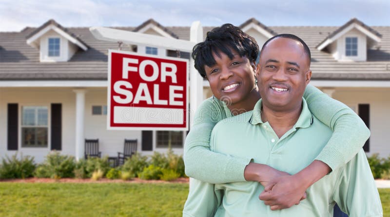 Happy African American Couple In Front of Beautiful House and Fo