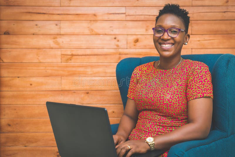 Happy African-American Lady working with laptop at home