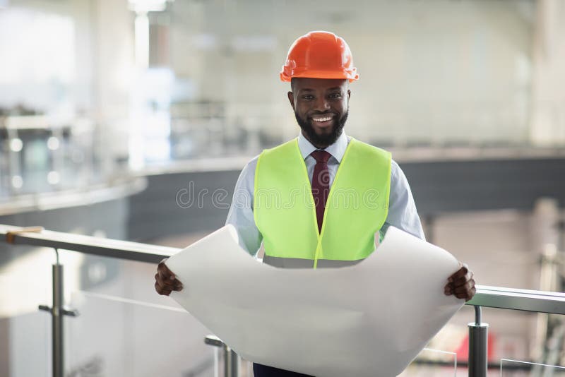 happy-african-american-man-engineer-holding-paper-drawing-template