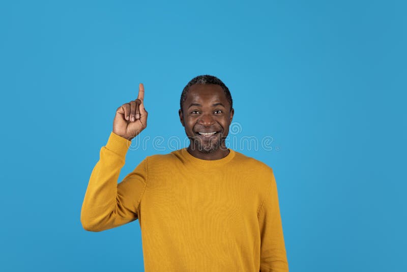 Happy African American Man Pointing Upwards Showing Eureka Gesture