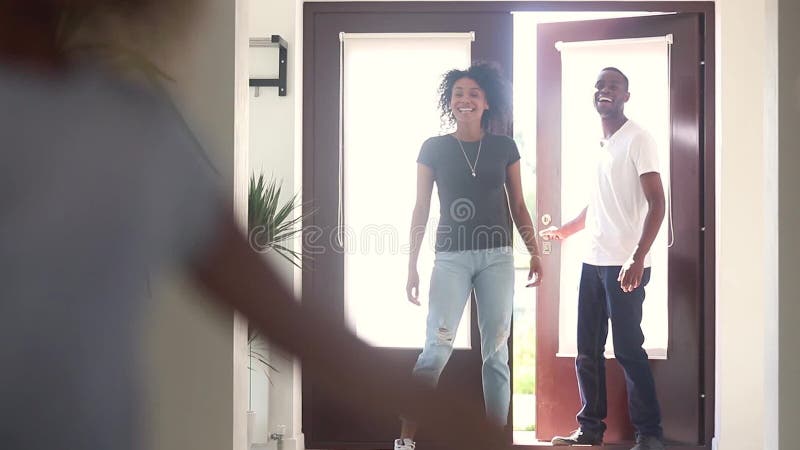 Happy african child girl with parents running into new house