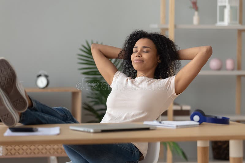 Happy african girl student relaxing finished study sit at desk royalty free stock photography Happy african girl student relaxing finished study sit at desk royalty free stock photography