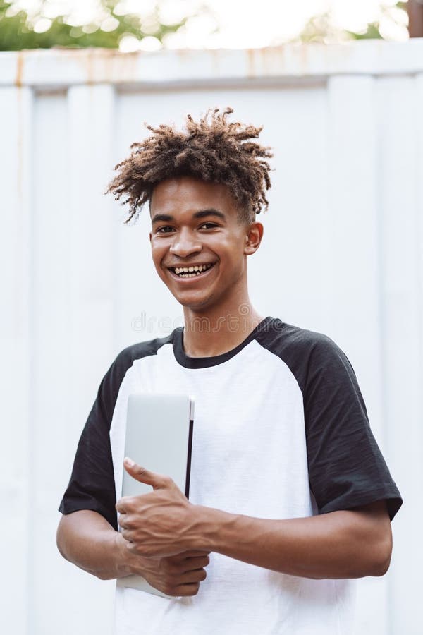 Happy african man student standing outdoors royalty free stock photo Happy african man student standing outdoors royalty free stock photo