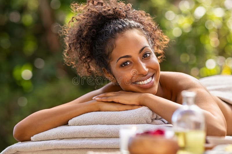 Happy african woman in resort spa